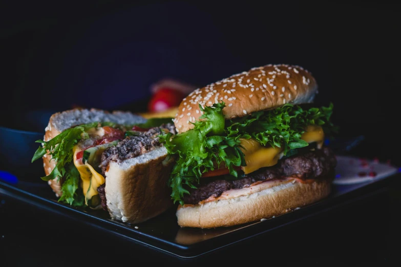 a close up of two hamburgers on a plate, pexels contest winner, 🦩🪐🐞👩🏻🦳, profile photo, background image, with a black background