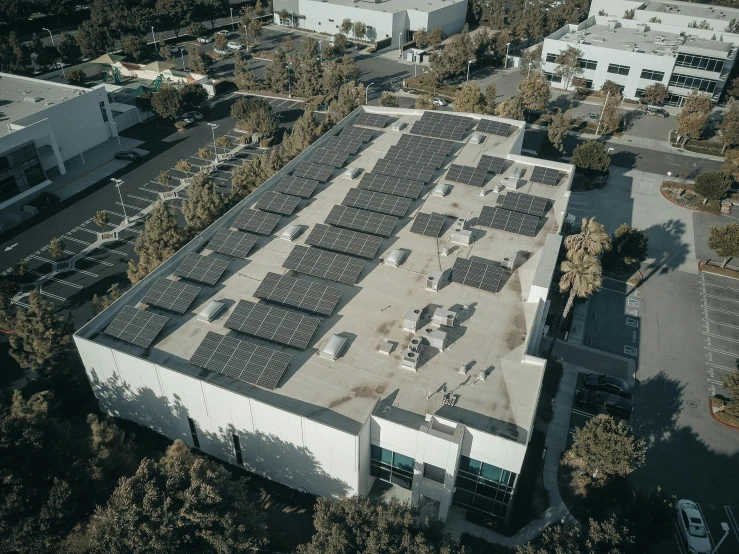 an aerial view of a building with solar panels on the roof, by Ryan Pancoast, renaissance, ultrastation hq, lv, exterior wide shot, low quality photo