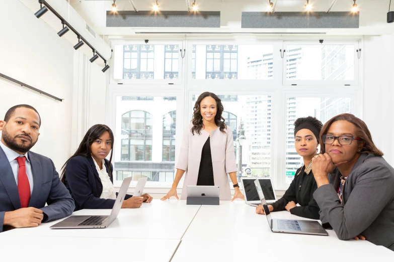 a group of business people sitting around a conference table, by Carey Morris, pexels contest winner, black female, standing on a desk, avatar image, modeled