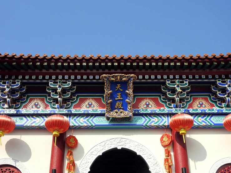 a building with a clock on the top of it, inspired by Pu Hua, cloisonnism, archway, colour photograph, 中 元 节, square