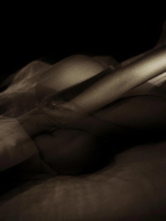 a close up of a person laying on a bed, inspired by Germaine Krull, unsplash, tonalism, “ sensual, sepia, beautiful female body silhouette, ignant