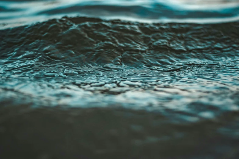 a close up of a body of water, inspired by Elsa Bleda, unsplash, wavy, soft vinyl, dimly - lit, earthwave