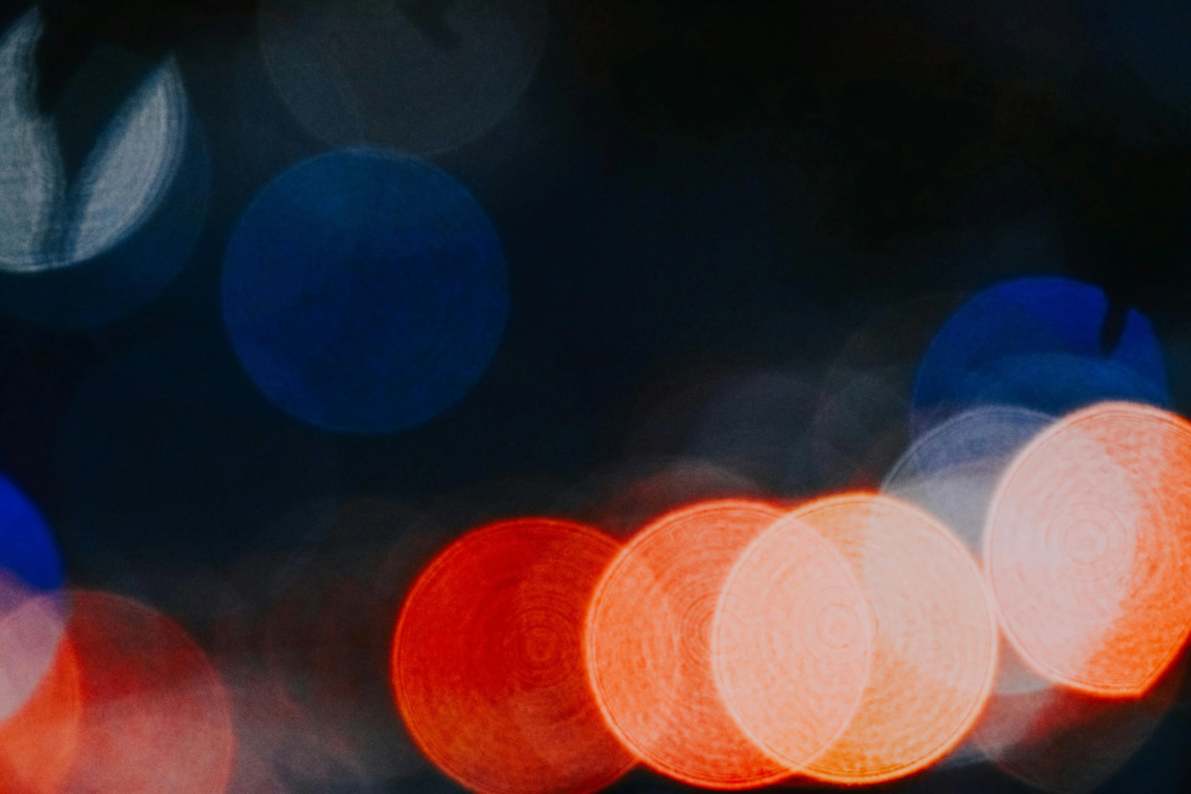 a blurry photo of a city street at night, unsplash, visual art, red and blue, dots abstract, blue and orange, closeup photograph