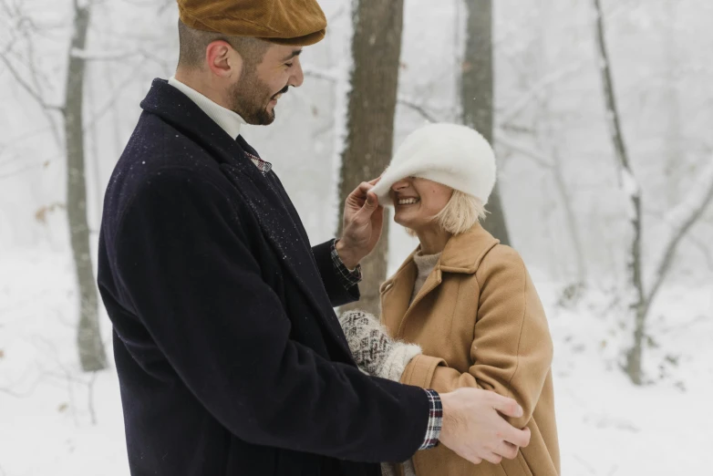 a man and woman standing next to each other in the snow, pexels contest winner, renaissance, wearing a french beret, thumbnail, brown, connection rituals