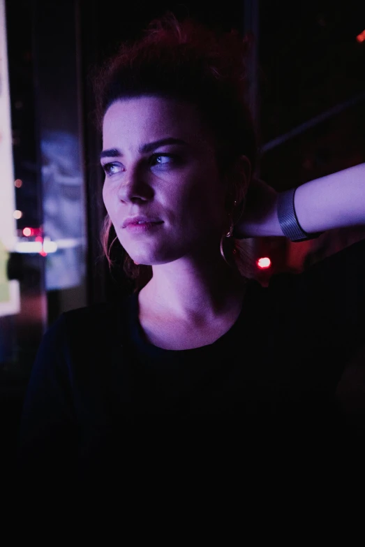 a woman holding a baseball bat in front of a window, a portrait, inspired by Elsa Bleda, unsplash, serial art, taken in night club, police lights shine on her face, looking smug, gif