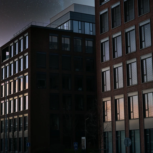 a couple of tall buildings sitting next to each other, a matte painting, by Sebastian Spreng, pexels contest winner, very dark night time, brick building, office building, evening starlight