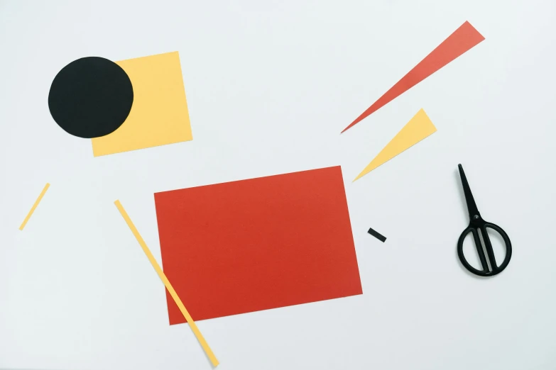 a pair of scissors sitting on top of a piece of paper, inspired by Alexander Calder, unsplash, suprematism, cut-out paper collage, red yellow, 2 - minute tabletop, scattered props