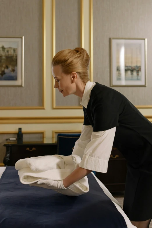 a woman that is standing over a bed, the iron lady, hotel room, on location, carefully crafted