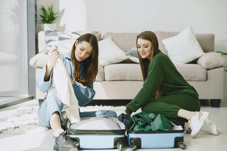 two women sitting on the floor with their luggage, with teal clothes, avatar image, gen z, inspect in inventory image