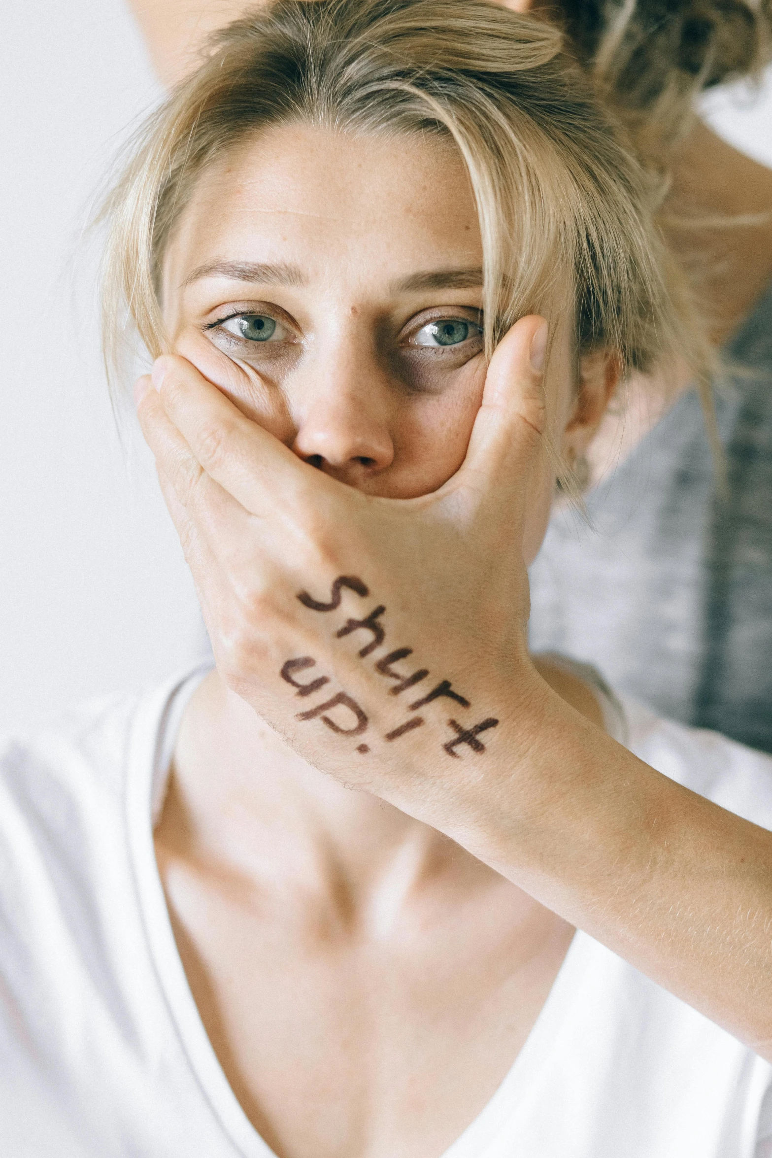 a woman covering her face with the words shit shit shit shit shit shit shit shit shit shit shit shit shit shit shit shit shit shit shit shit, a tattoo, inspired by Elke Vogelsang, shutterstock, portrait of annasophia robb, bruised, soft light