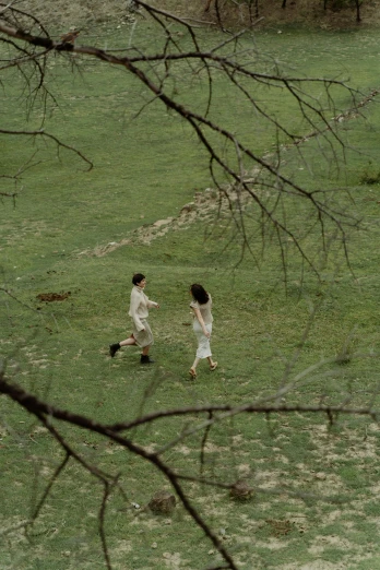 two children playing with a frisbee in a field, by Marina Abramović, renaissance, movie still frame, running in savana, high angle shot, walking through the trees