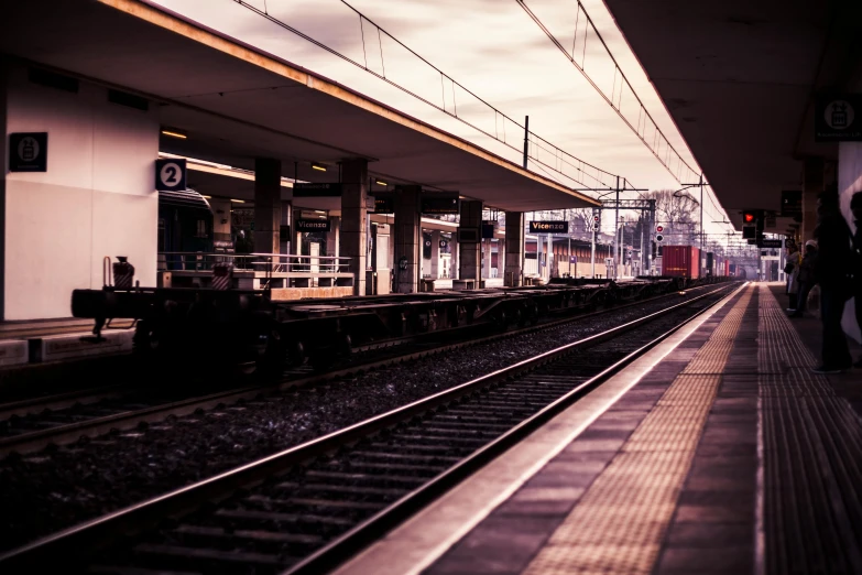 a train pulling into a train station next to a platform, unsplash, coloured photo, thumbnail, atmospheric photo, multiple stories