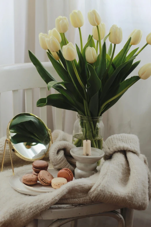 a table topped with a vase of flowers next to a mirror, tulip, beige and gold tones, designed for cozy aesthetics!, morning