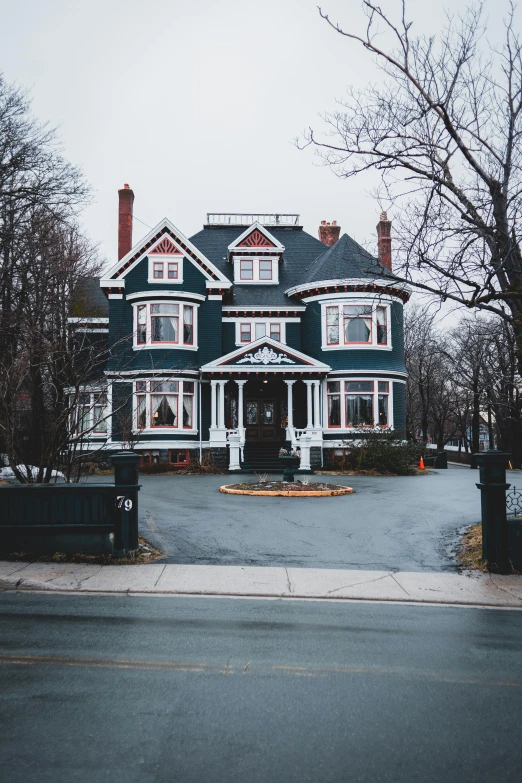 a large blue house sitting on the side of a road, pexels contest winner, red brown and grey color scheme, on a dark winter's day, interior of a victorian house, white building