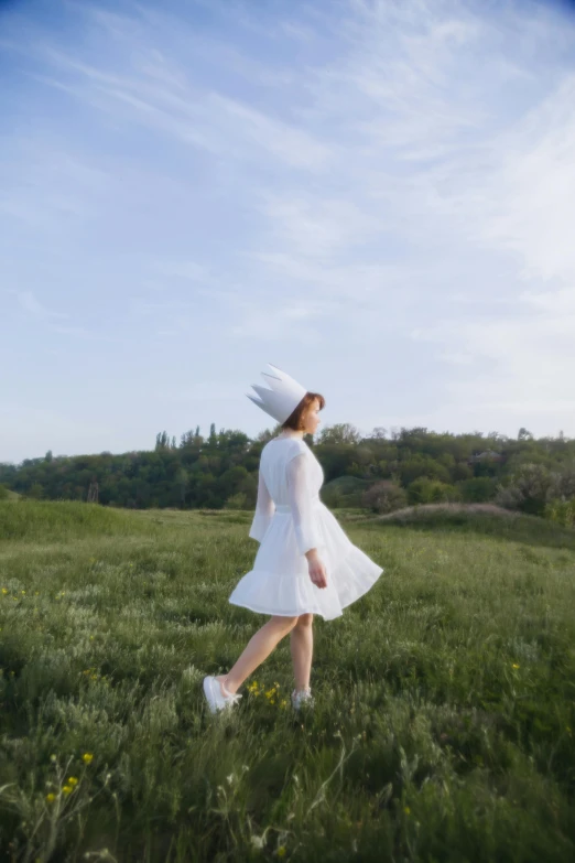 a woman in a white dress and hat walking through a field, an album cover, unsplash, dressed as a pastry chef, park ji-min, 15081959 21121991 01012000 4k, distant full body view