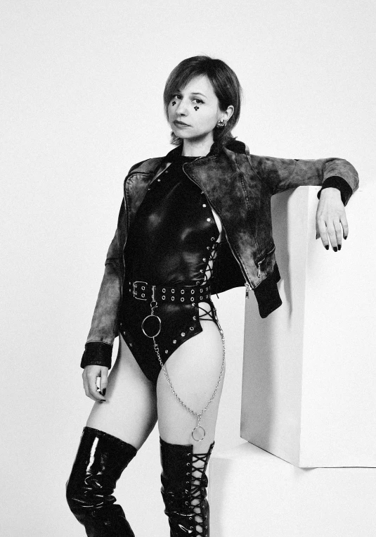 a black and white photo of a woman in latex, tumblr, renaissance, aurora aksnes and zendaya, body harness, leather and suede, joey king