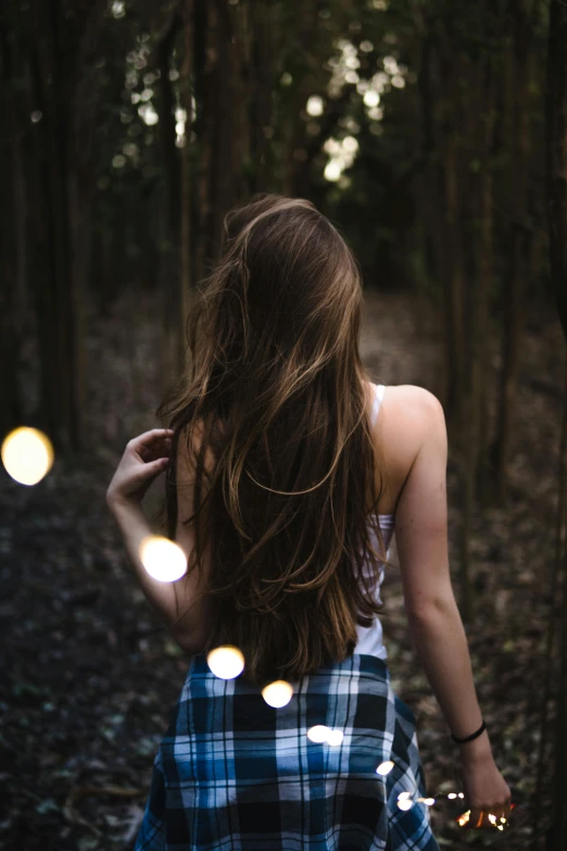 a woman walking through a forest holding a guitar, inspired by Elsa Bleda, pexels contest winner, hair : long brown, evening lights, hair texture, teenage girl