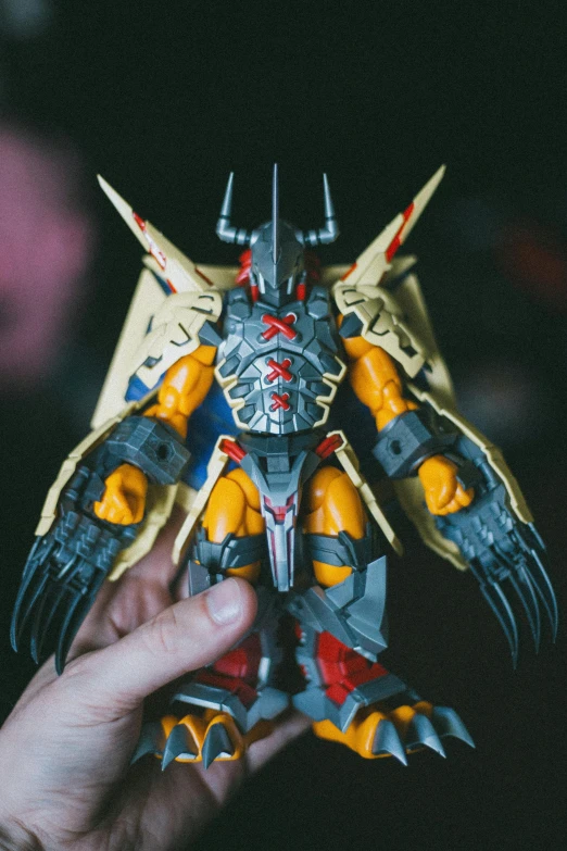 a close up of a person holding a toy, inspired by Xul Solar, transformers beast wars, instagram post, tabletop model, symmetric armor