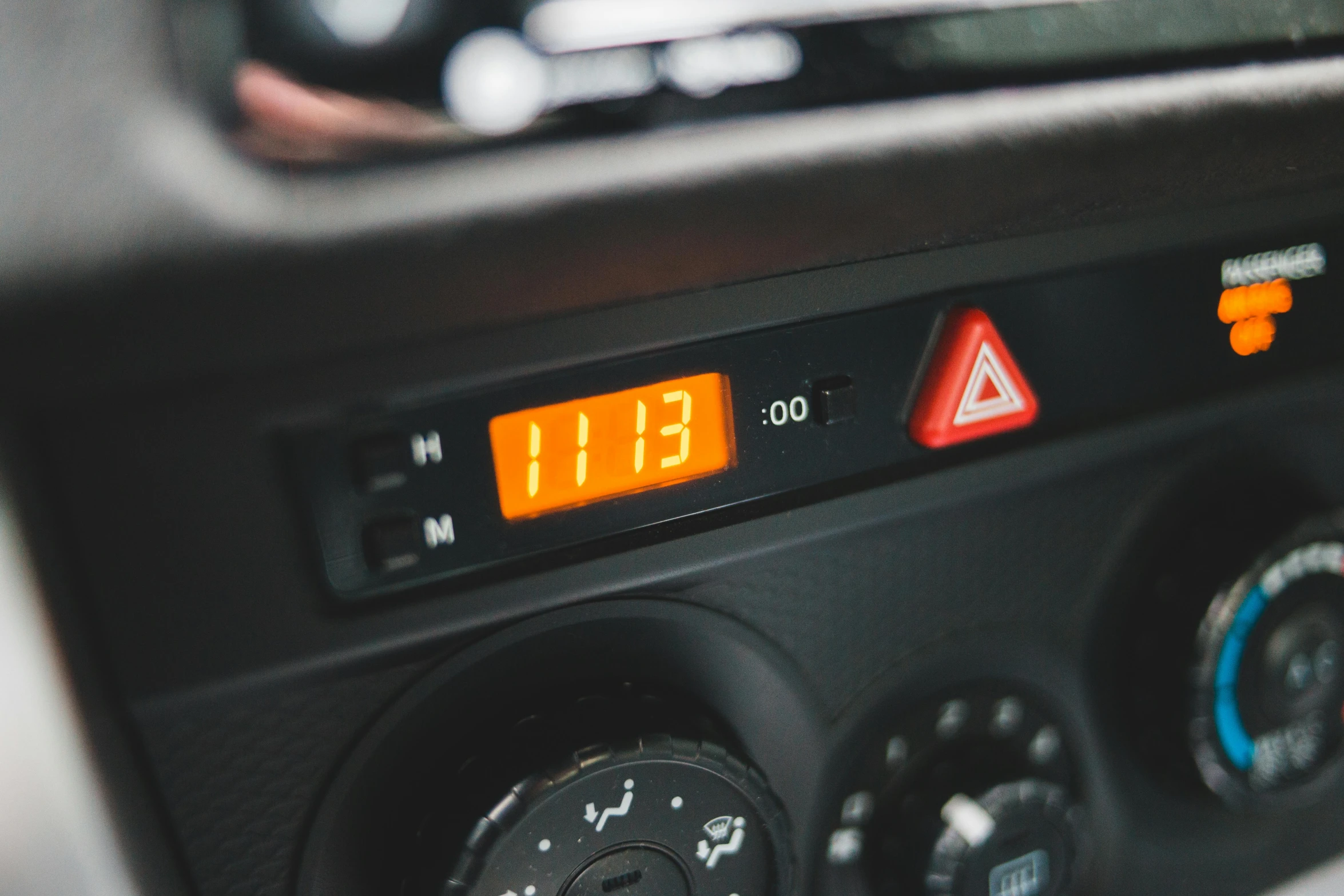 a close up of a control panel in a car, a portrait, by Joe Bowler, unsplash, orange details, cold colour temperature, land rover defender, clock iconography