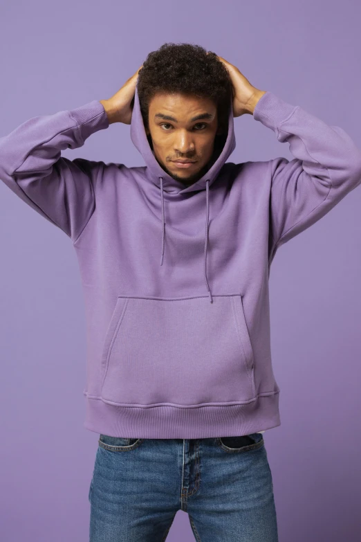 a young man in a purple hoodie posing with his hands on his head, trending on pexels, renaissance, matt mute colour background, tonal topstitching, thumbnail, official product image