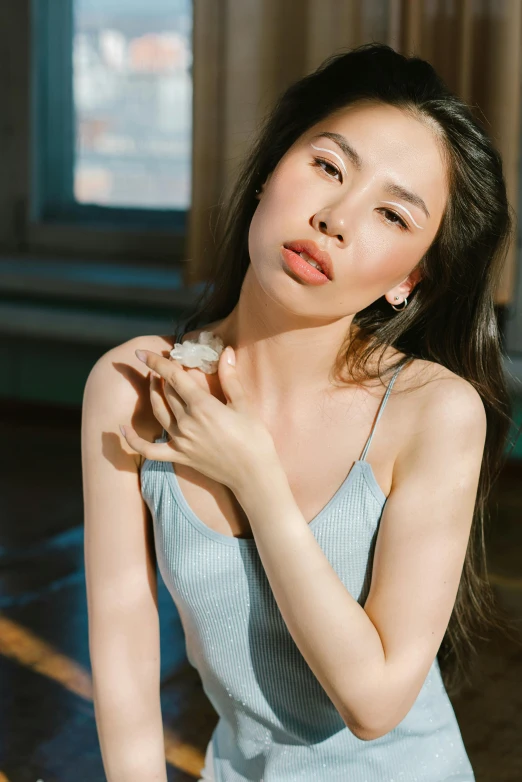 a woman in a blue dress posing for a picture, by helen huang, trending on pexels, photorealism, natural soft pale skin, wearing a low cut tanktop, asian features, photoshoot for skincare brand