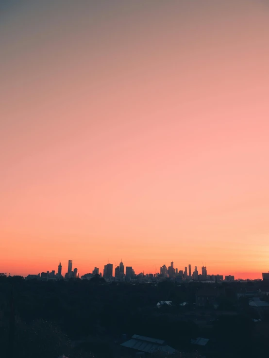 a view of a city skyline at sunset, pexels contest winner, trending on vsco, hq 4k phone wallpaper, the sky is pink, melbourne