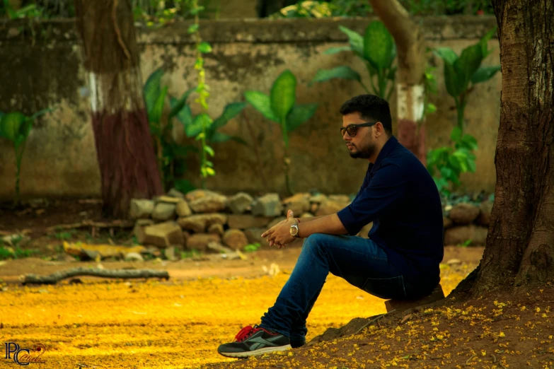 a man sitting on the ground next to a tree, by Max Dauthendey, pexels contest winner, jayison devadas style, avatar image, side profile shot, casually dressed
