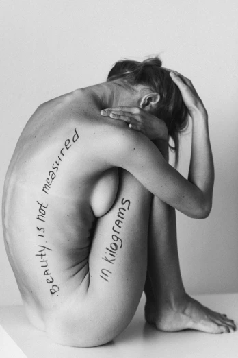 a black and white photo of a naked woman, an album cover, by Silvia Pelissero, tumblr, massurrealism, words, body modification, ffffound, existence is pain