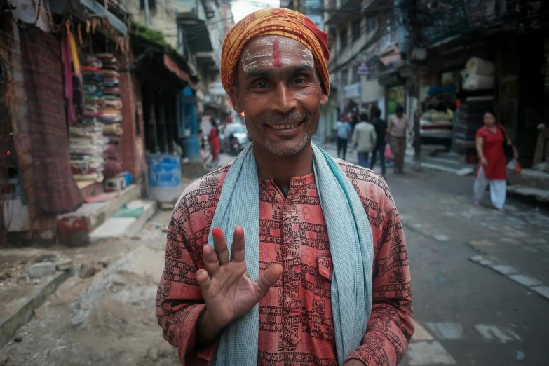 a man that is standing in the street, inspired by Steve McCurry, pexels contest winner, renaissance, nepal, waving at the camera, wearing festive clothing, full frame image