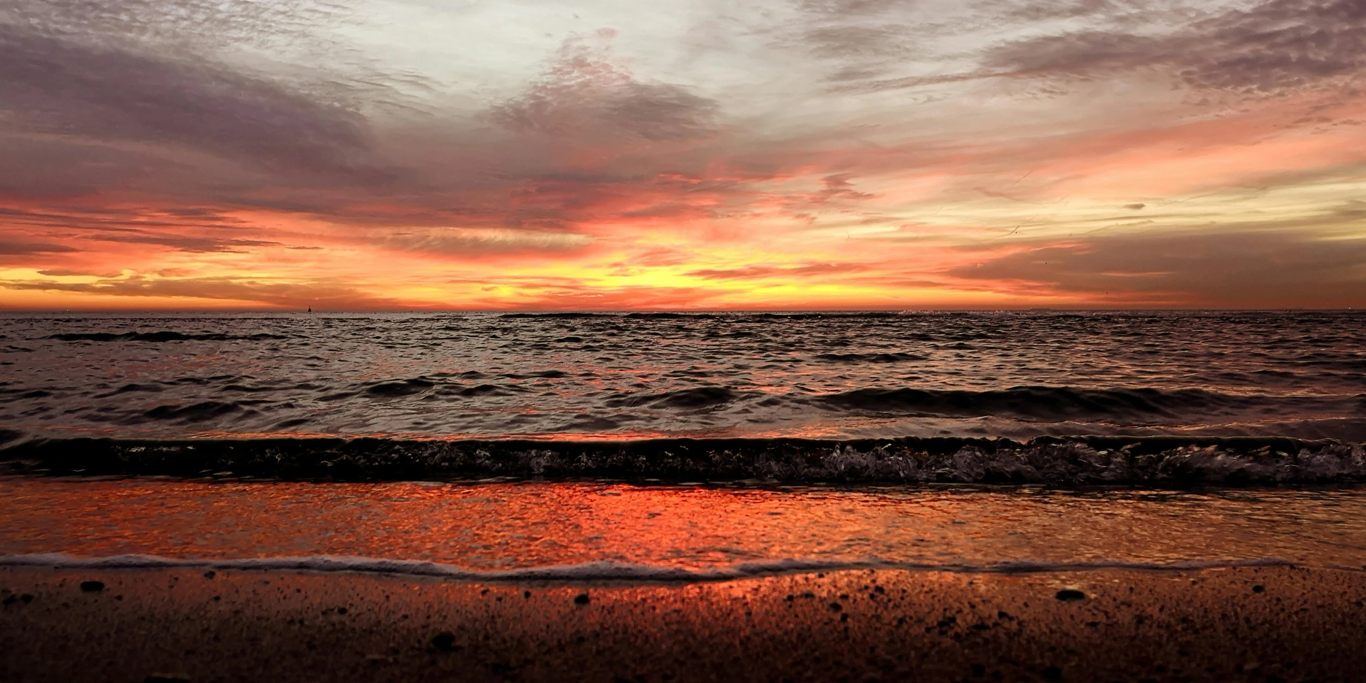 the sun is setting over the ocean on the beach, by Robbie Trevino, pexels contest winner, red and orange colored, slide show, sunken, brown