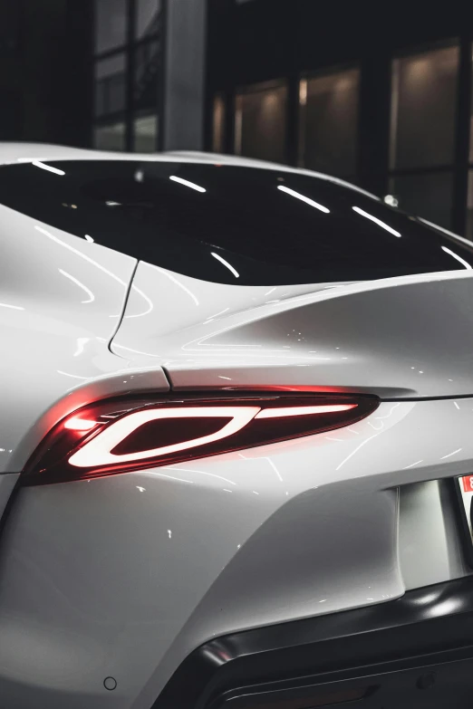 the rear end of a silver sports car, by Adam Marczyński, pexels contest winner, glowing veins of white, toyota supra, clean detail 4k, ✨🕌🌙