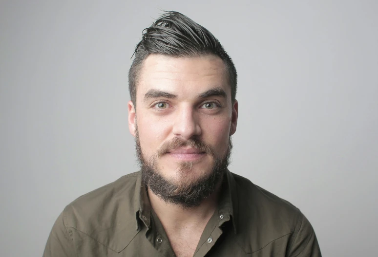 a close up of a person with a beard, plain background, chris mcgrath, unibrow, julian ope