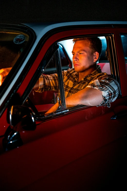 a man driving a red car at night, a portrait, by Matt Cavotta, movie still of a tired, owen klatte, 15081959 21121991 01012000 4k, square