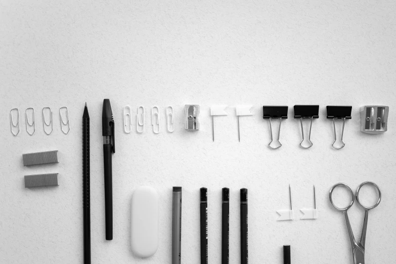 a number of tools laid out on a table, concept art, by Karl Buesgen, unsplash, minimalism, black on white paper, in plastic, behance lemanoosh, wire management