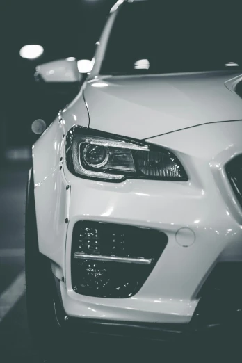 a white car parked in a parking lot at night, pexels contest winner, subaru, dynamic closeup, black on white, custom headlights
