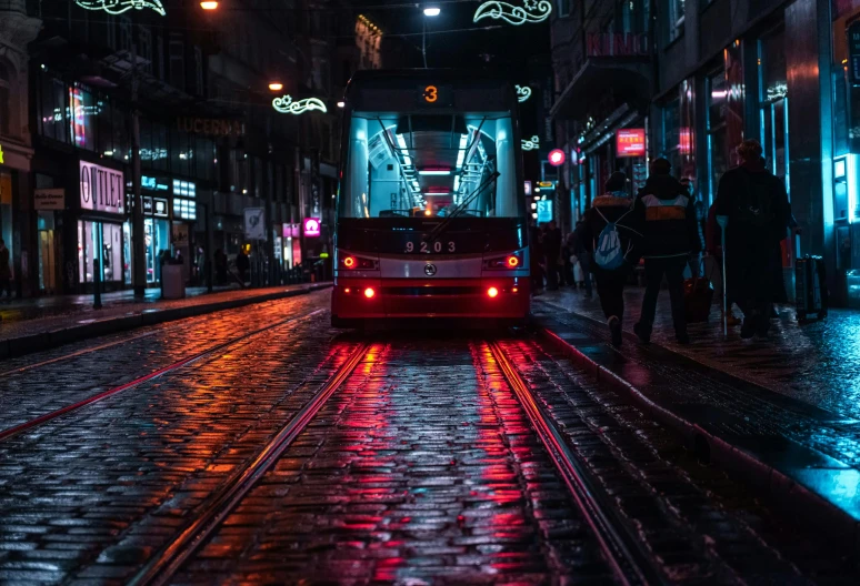 a red bus driving down a city street at night, by Kristian Zahrtmann, pexels contest winner, ominous neon lighting, istanbul, street tram, wet floor on streets