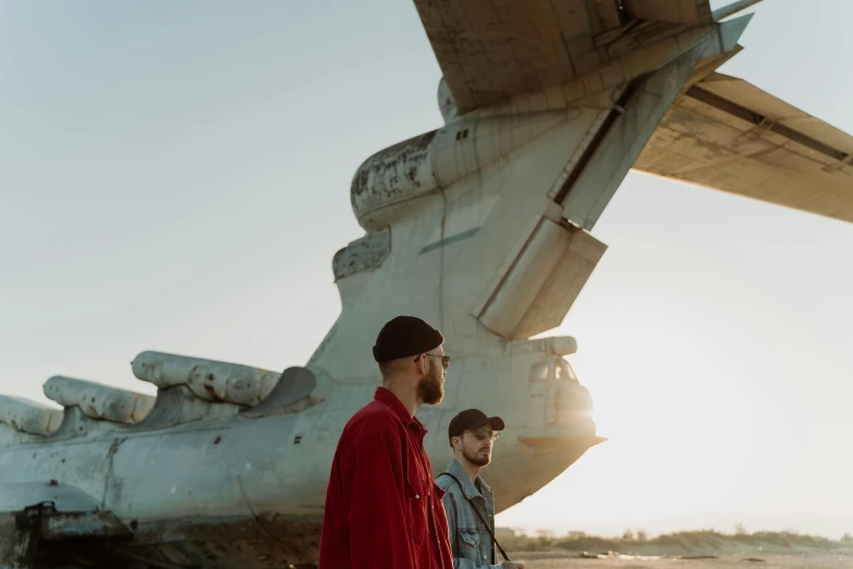two men standing in front of an airplane, a portrait, by Emma Andijewska, pexels contest winner, visual art, mrbeast, on a landing pad, music video, soviet style