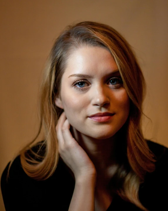 a woman in a black shirt posing for a picture, sydney hanson, translucent, her skin is light brown, face centred