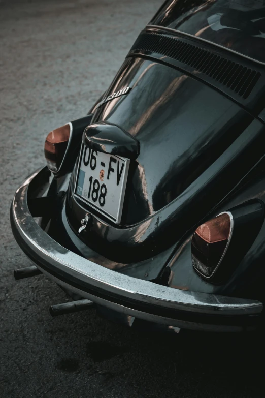a black vw beetle parked on the side of the road, pexels contest winner, renaissance, close-up shot taken from behind, grey metal body, high quality photo, 256435456k film