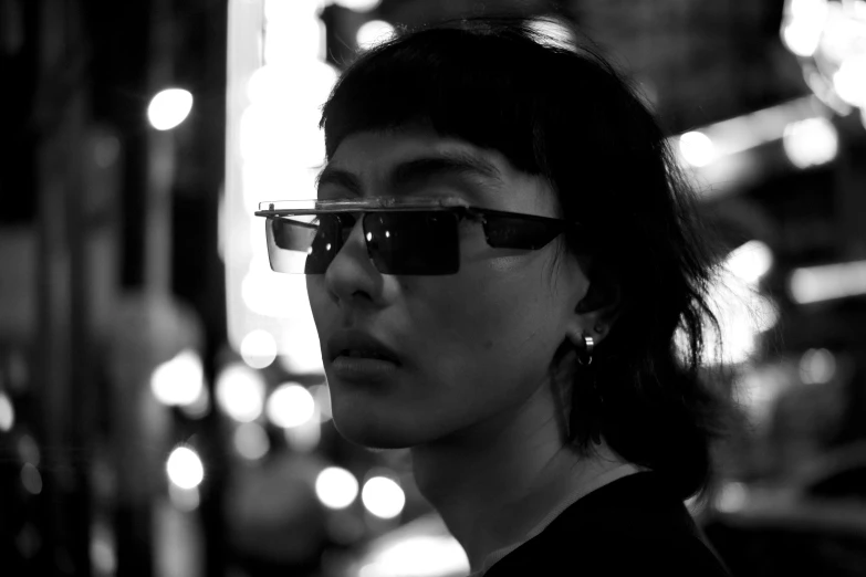 a black and white photo of a woman wearing glasses, by Jan Rustem, unsplash, neo-dada, street night, in style of kar wai wong, with short hair, digital sunglasses
