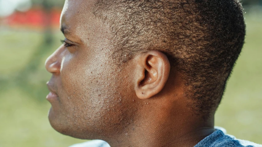 a close up of a person with a cell phone, by Daniel Lieske, trending on pexels, hyperrealism, hatched ear, brown skin like soil, masculine jawline!, side view close up of a gaunt