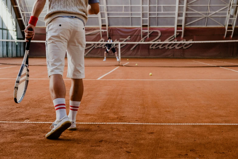 a man standing on a tennis court holding a racquet, by Julia Pishtar, pexels contest winner, renaissance, red brown and white color scheme, shorts, belgium, in-game