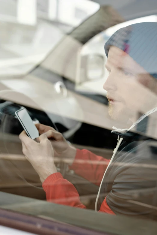 a woman sitting in a car looking at her cell phone, by Haukur Halldórsson, happening, photo of a man, square, avatar image, dynamic closeup