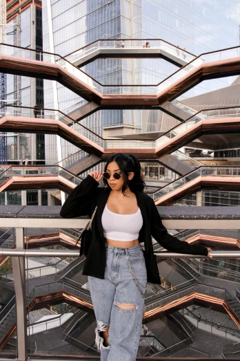 a woman wearing ripped jeans and a black jacket, inspired by Cheng Jiasui, trending on pexels, zaha hadid building, ☁🌪🌙👩🏾, physical : tinyest midriff ever, thicc