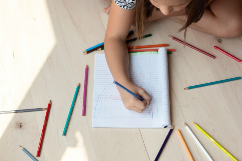 a little girl sitting on the floor drawing with colored pencils, a child's drawing, by Nicolette Macnamara, pexels contest winner, schematic in a notebook, vertical portrait, multicoloured, opening shot