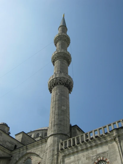 a tall tower with a clock on top of it, hurufiyya, shades of blue and grey, lead - covered spire, istanbul, taken in the mid 2000s