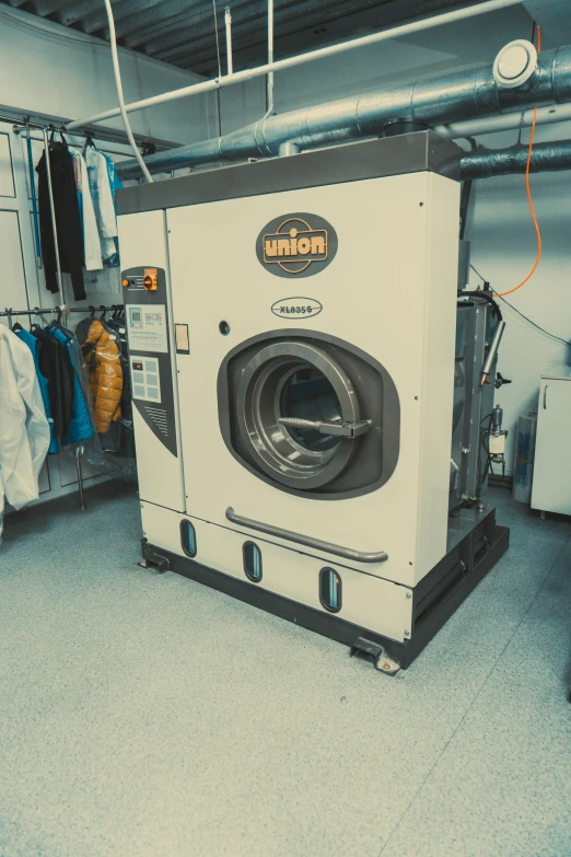 a washing machine sitting inside of a laundry room, a silk screen, unsplash, private press, industrial machinery, technical suit, a 35mm photo, thumbnail