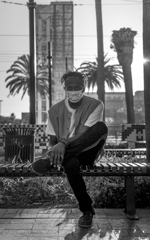 a black and white photo of a man sitting on a bench, masked, playboi carti, los angeles ca, postprocessed)