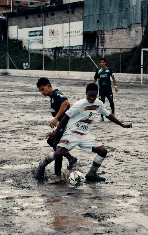 a group of young men playing a game of soccer, a picture, dribble, happening, rainfall and mud, 8k 50mm iso 10, movie still 8 k, grainy