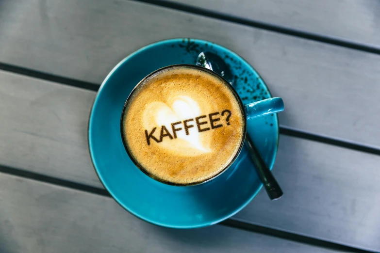 a cup of coffee with the word kaffe written on it, inspired by Franz Karl Basler-Kopp, pexels contest winner, teal, do you want to know, no - text no - logo, kami
